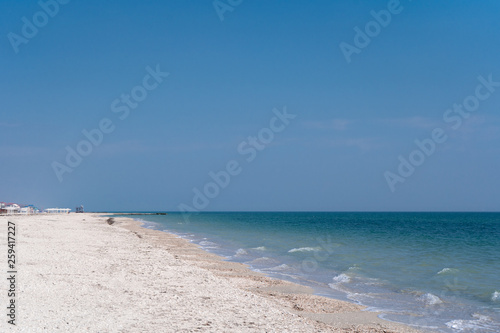 Restless sea and sandy-shell beach