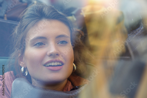 Smiling woman sitting in car