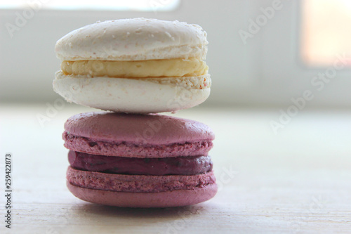 Colorful French or Italian macaroon stack cakes / Macaroon cakes. Assorted macaroon cakes stacked on top of each other on a light background. Copy space. Delicious dessert.