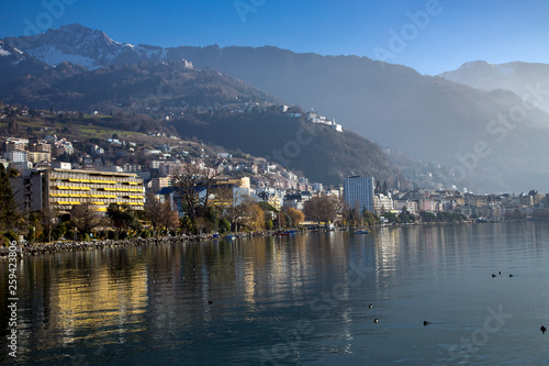 Panorama city of Montreux about of Lake Leman or Lake of Geneva with morning mist over the water surface. At the background are the snow-covered Alps in Montreux, Switzerland © Tanya Keisha