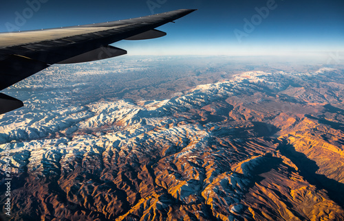 Aerial View from an Airplane. Flying above Beautiful Land at Sunrise.