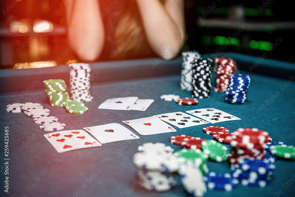 Poker chips and playing cards on table in casino Poker chips and playing cards on table in casino