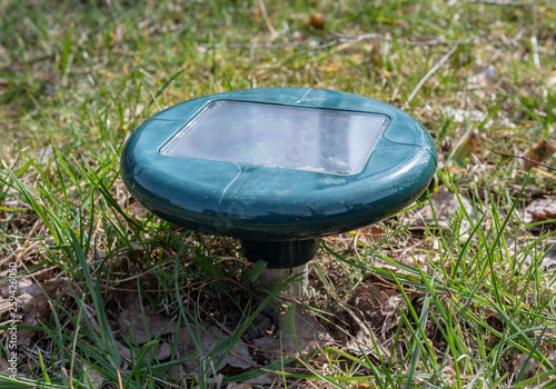 Sonic solar powered mole, rodent repeller set in the garden. photo