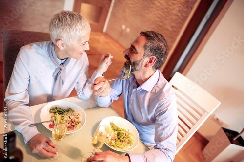 Portrait of mature couple eating healthy food at home