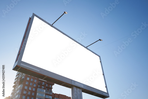 3x6 big billboard standing in the city against the sky during the daytime, with a white advertising space mockup photo