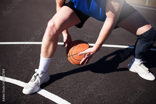 Basketball player playing basketball at the sport ground,low angle