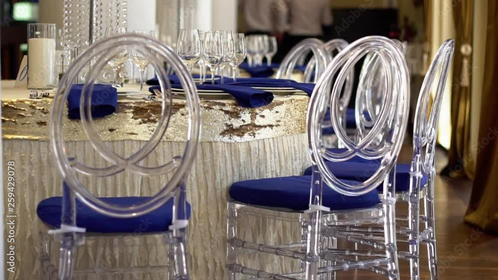 Transparent plastic chairs for wedding guests. Design in blue. Transparent plastic chairs for wedding guests. Design in blue.