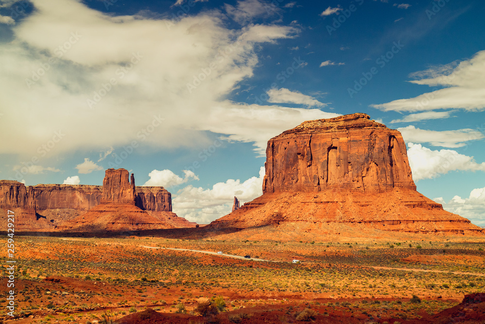 Scenic Landscape, Sunny Day in Monument Valley Navajo Tribal Park, Beautiful Red Rock Formation and Cloudy Blue Sky