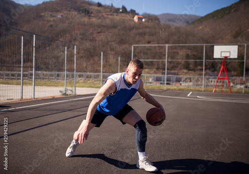 Street basketball player with ball © Novak