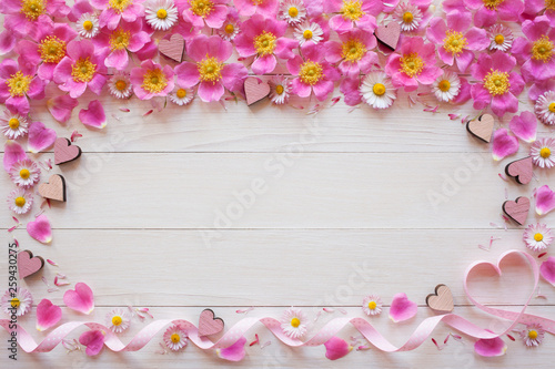 Fototapeta Naklejka Na Ścianę i Meble -  Background with flowers rose hips, daisies, hearts and ribbon
