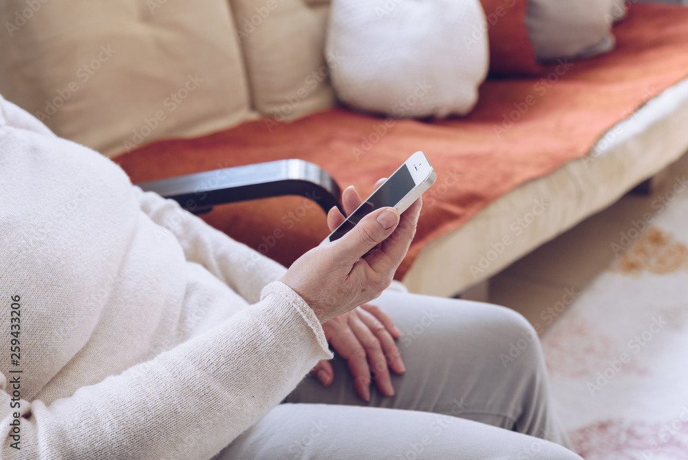 Elderly woman  using a smart Phone.