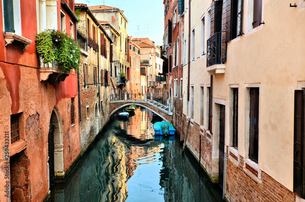 Beautiful canals with reflections and bridge in Venice, Italy