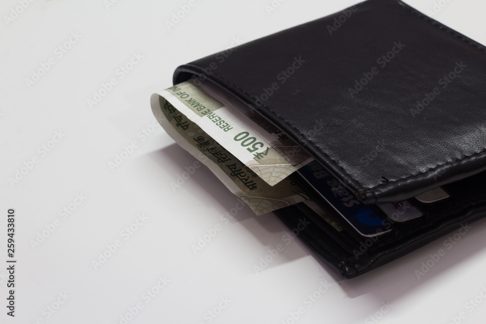 Black wallet with money isolated on white background with space for text Black wallet with money isolated on white background with space for text