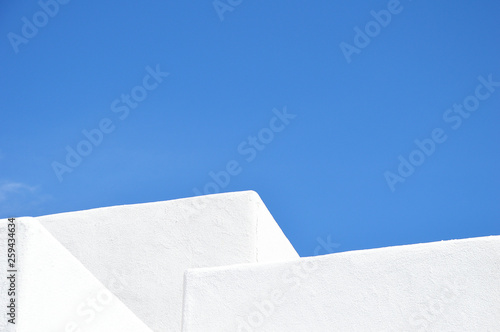 white adobe house against blue sky