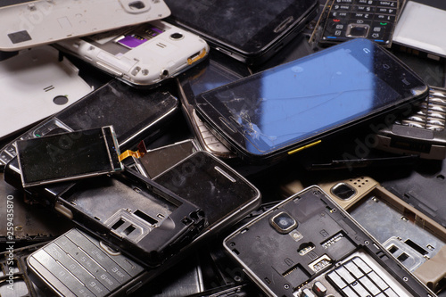 Telephones and smartphones of various types and generations not suitable for repair. Electronic scrap. photo