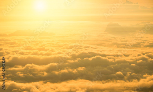 Sunrise foggy mist covered mountain forest landscape top view yellow sky background