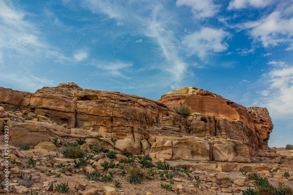 Fototapeta premium picturesque sand stone rocky wilderness outdoor environment of bare mountain ridge in colorful contrast photography from Middle East Jordan country desert