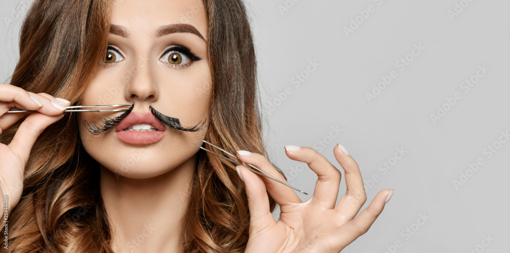 Beauty woman hold makeup professional tools for manicure cuticle forceps scissors tweezers make funny mustache with eyelashes Beauty woman hold makeup professional tools for manicure cuticle forceps scissors tweezers make funny mustache with eyelashes