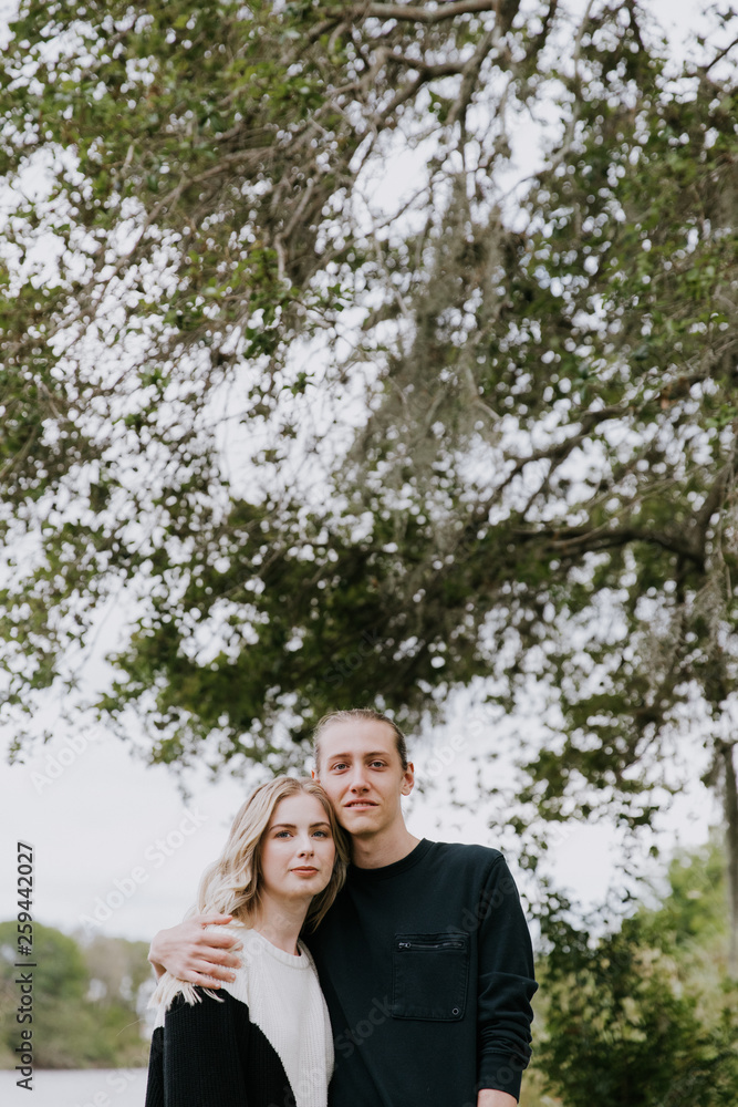 Young Romantic Couple Holding Each Other for Couples Portraits by the Pond Outside in Nature