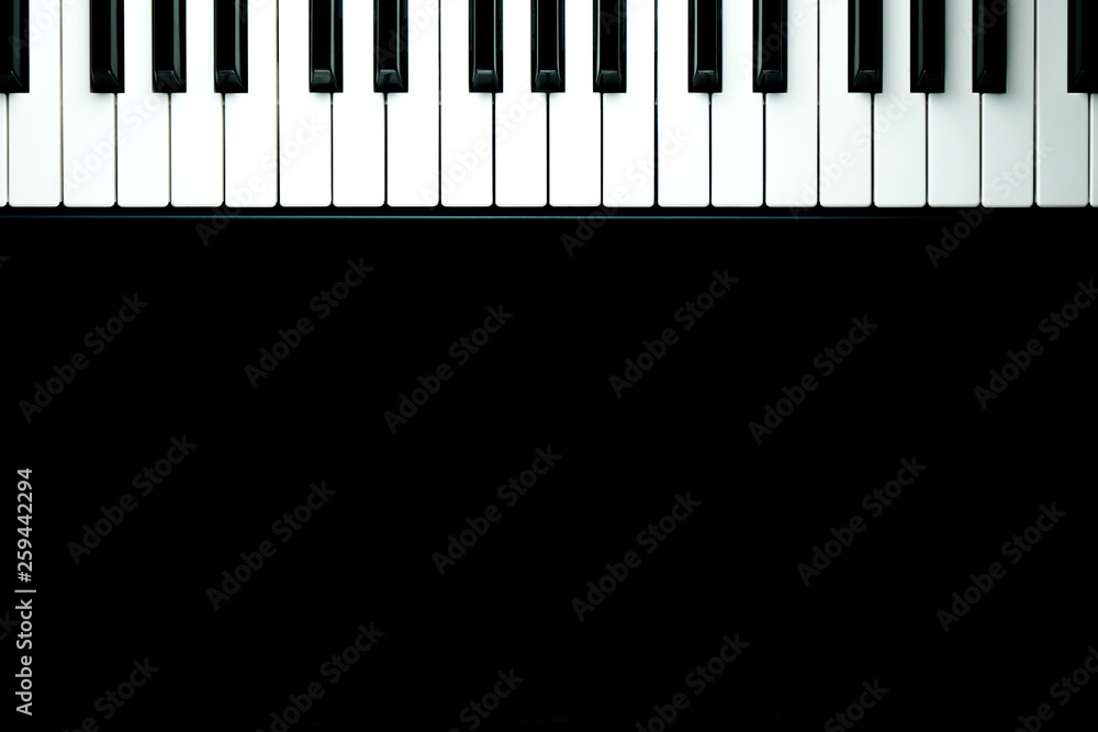 Black background with piano keys close up Black background with piano keys close up