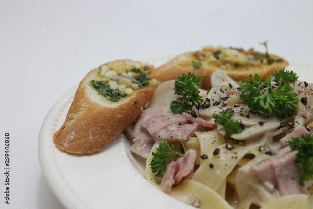 Italian Food, Fettuccine Alfredo, Italian Cream Sauce with Mushroom and Ham, topped with Parsley Italian Food, Fettuccine Alfredo, Italian Cream Sauce with Mushroom and Ham, topped with Parsley