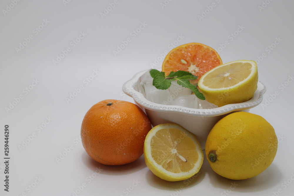 Orange , Lemon and Mint Leaves on White background Citrus Fruits full with Vitamin C, delicious and Refreshing, good for health, valued as part of a nutritious and tasty diet Orange , Lemon and Mint Leaves on White background Citrus Fruits full with Vitamin C, delicious and Refreshing, good for health, valued as part of a nutritious and tasty diet