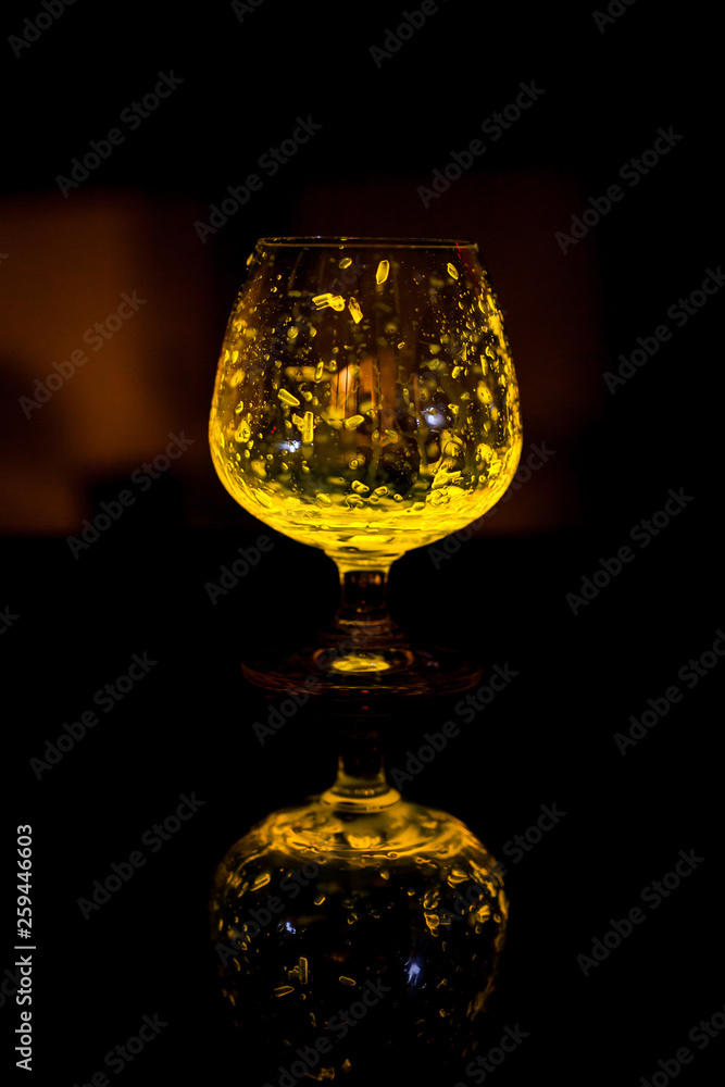 Glass of whiskey glow in the dark.