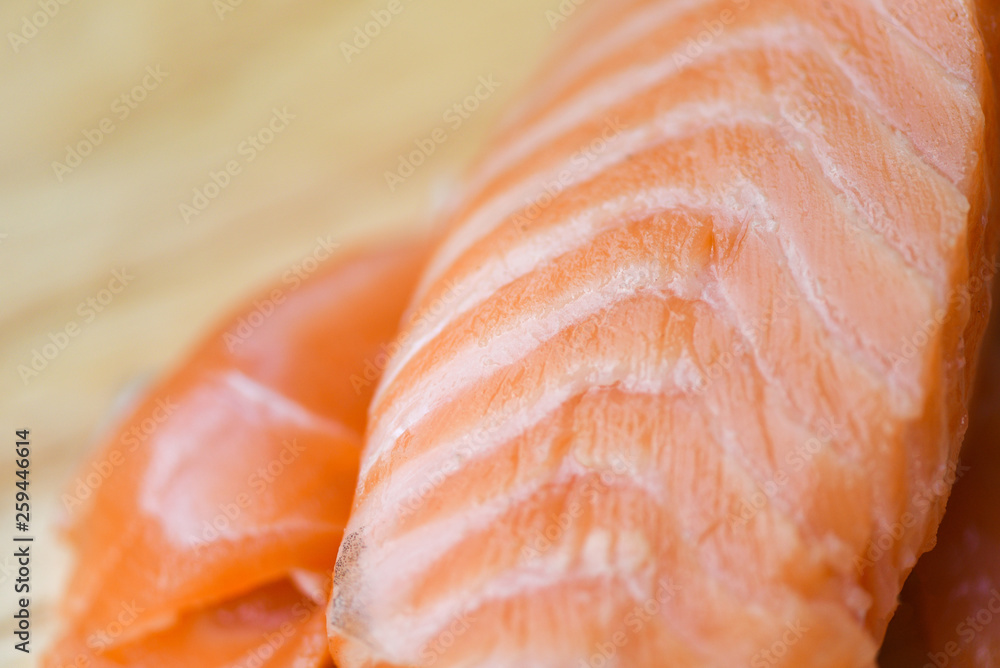 Fresh salmon fillet on cutting board / Close up of raw salmon fish seafood