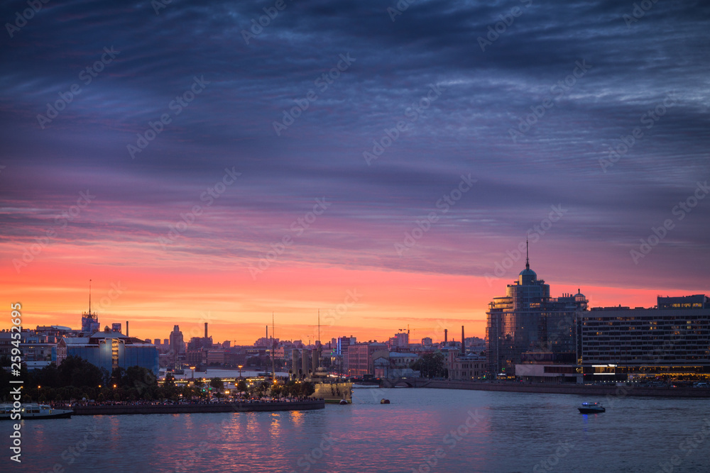 City at sunset. Embankment of the river and buildings at sunrise.