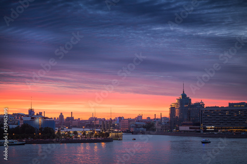City at sunset. Embankment of the river and buildings at sunrise.
