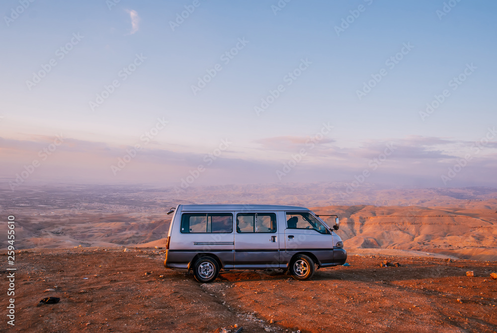 Bus in the desert of Jordan on sunset.