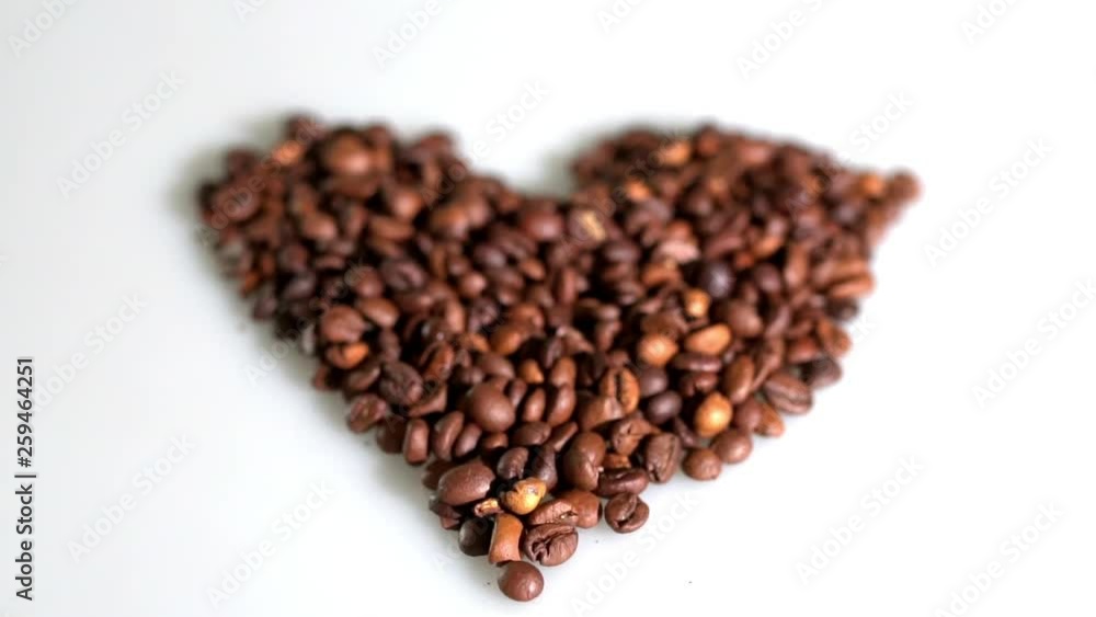 coffee beans are collected in the shape of a heart on a white background. coffee beans are collected in the shape of a heart on a white background.