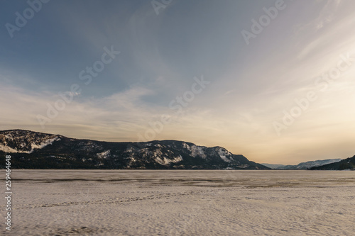 Sunset landscape of frozen Little Shuswap Lake British Columbia Canada.