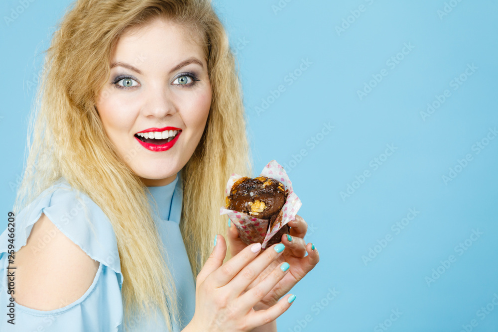 Attractive woman holds cake in hand Attractive woman holds cake in hand