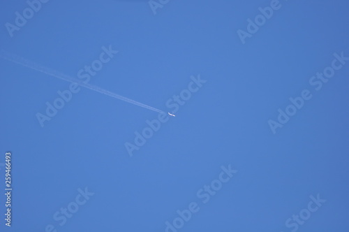 The plane is flying in the blue sky to bring passengers to the destination with quickly and safety.