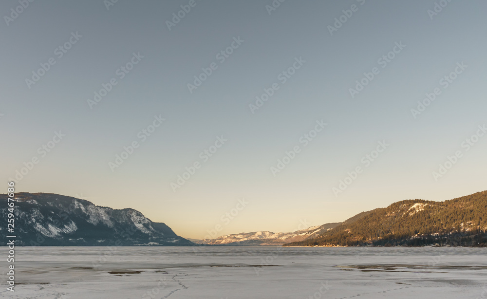 Cold morning landscape of frozen Little Shuswap Lake British Columbia Canada.