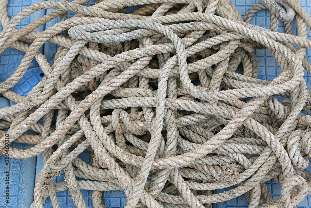Close-up pile of ship rope on floating pontoon.