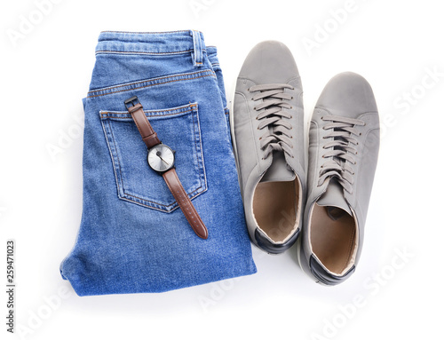 Jeans, watch and shoes on white background