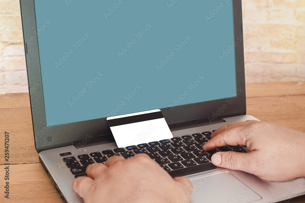 Hand Typing On Laptop Keyboard With Credit Card, Online Shopping Concept . Hand Typing On Laptop Keyboard With Credit Card, Online Shopping Concept .