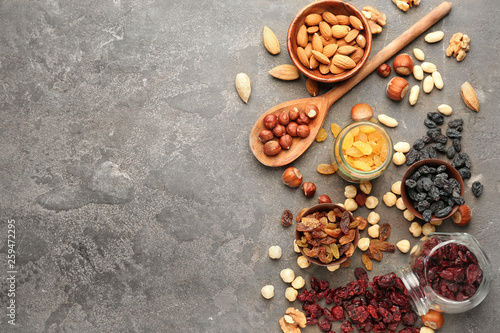 Fototapeta Naklejka Na Ścianę i Meble -  Assortment of tasty dried fruits and nuts on grey background
