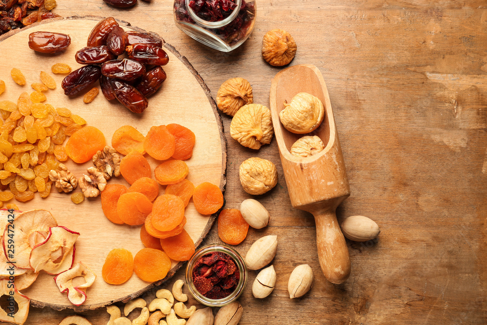 Assortment of tasty dried fruits and nuts on wooden table Assortment of tasty dried fruits and nuts on wooden table
