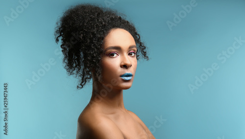 Photography Portrait of beautiful African-American woman with unusual makeup on color backgr