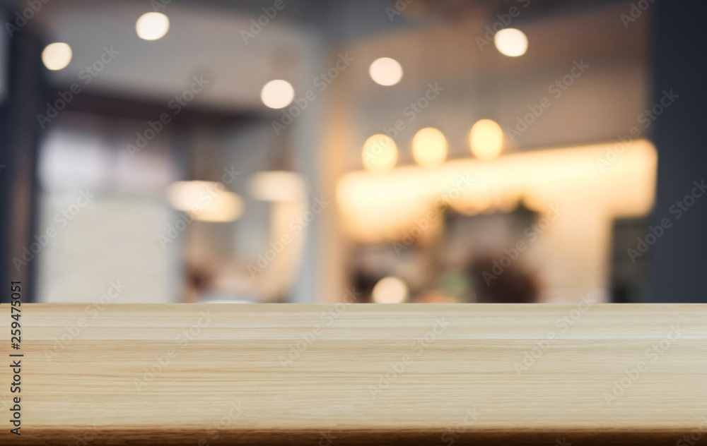 Selective Empty wooden table and blurred background of abstract in front of coffee shop or restaurant for display of product or for montage Selective Empty wooden table and blurred background of abstract in front of coffee shop or restaurant for display of product or for montage