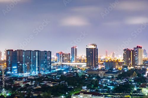 Cityscape from high rise building at night with skyline and clouds. skyscraper in metropolis town with beautiful neon light Bangkok Thailand. © Small fish