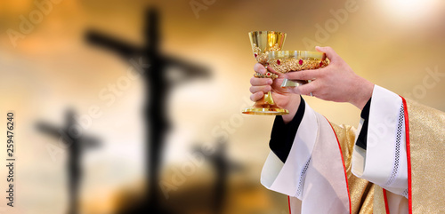 Holy communion on the background of three crosses on top of Golgotha. Easter holiday concept with empty space for text.