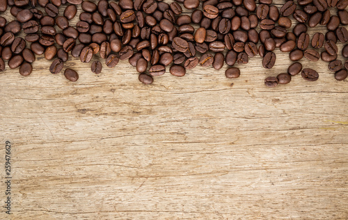 Flame with Coffee beans on old wood background 