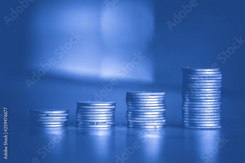 stacks of money coin background concept saving money with blue filter