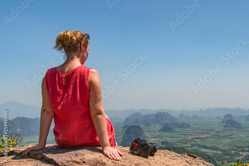 Woman phortographer relaxing on mountain top © Antonio