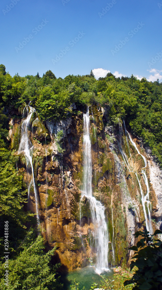 Scenic view of the large waterfall, Plitvice Lakes in Croatia, National Park, sunny day with blue sky