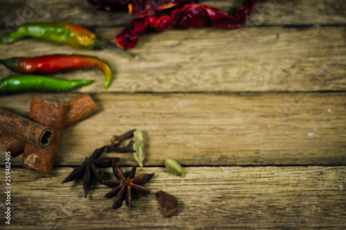 Variety of asian spices and kitchen ingredients on wooden board. Selective focus.